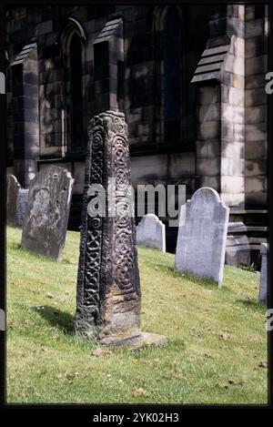 All Saints' Church, Anglo-Skandinavischer Kreuzschacht, Bakewell, Derbyshire Dales, Derbyshire, 1991. der englisch-skandinavische Kreuzschacht auf dem Friedhof der Allerheiligen-Kirche. Das Kreuz stammt vermutlich aus dem späten 9. Oder 10. Jahrhundert. Sie wurde im 19. Jahrhundert auf einem Feld in Two Dales entdeckt und später auf den Kirchhof der Allerheiligen-Kirche verlegt. Stockfoto