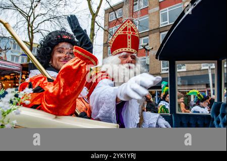 Nijmegen, Gelderland, Niederlande. November 2024. Nikolaus und seine Helferin begrüßen das Publikum. Am ersten Samstag nach dem 11. November trifft die rot-weiß-bekleidete Sinterklaas (St. Nikolaus) in mehreren niederländischen Städten ein. In Nijmegen ging Sinterklaas auf einer Route durch das Stadtzentrum, begleitet von seinen Helfern, dem Pieten (Peters), der Kindern und Erwachsenen traditionelle Süßigkeiten schenkte. (Credit Image: © Ana Fernandez/SOPA Images via ZUMA Press Wire) NUR REDAKTIONELLE VERWENDUNG! Nicht für kommerzielle ZWECKE! Stockfoto