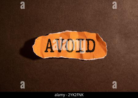 Der Text AVOID steht auf Holzblöcken auf hellem Hintergrund Stockfoto