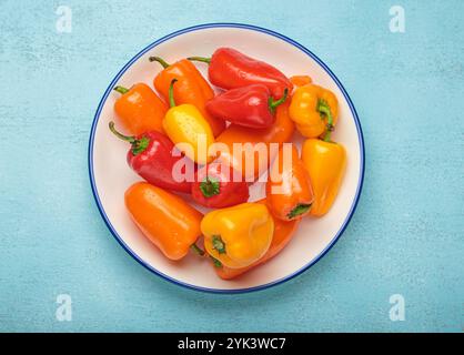 Bunte Mini-Paprika auf einem weißen Teller Stockfoto