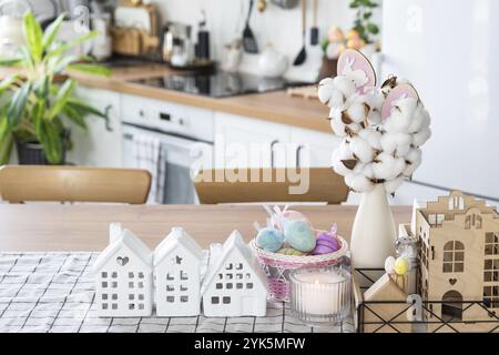 Schlüssel zum Haus eines gemütlichen Hauses mit Osterdekor mit Hase und Eiern auf dem Tisch der Küche. Gebäude, Entwurf, Projekt, Umzug in ein neues Haus, Hypothek, Versicherung Stockfoto