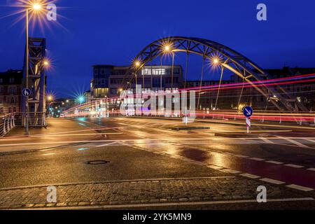 Luitpoldbrücke, Bamberg, Willy-Lessing-Straße, Blaue Stunde, Stadtbrücke bei Nacht mit Lichtspuren von Autos und modernen Gebäuden im Hintergrund Stockfoto