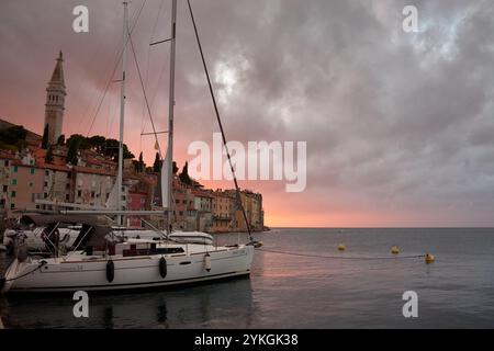 Rovinj, Istrien, Kroatien; 16. Oktober 2024: Der Charme der Küste von Rovinj, Istrien, während die Sonne untergeht und den Himmel in ein leuchtendes Rot verwandelt. Im Vordergrund Stockfoto