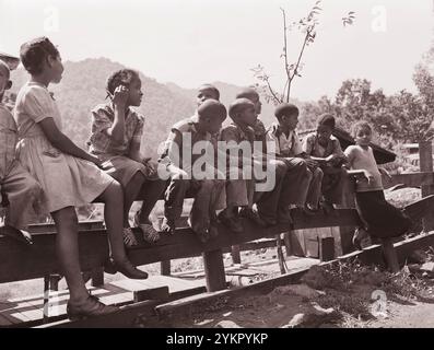 Vintage-Foto vom Leben amerikanischer Bergleute. Kinder von Bergleuten auf dem Zaun vor dem Howard-Haus. Gilliam Coal and Coke Company, Gilliam Mine, Gilliam, McDowell County, West Virginia. USA. August 1946 Stockfoto