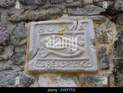 Steintafel mit zwei Fischen und einer Inschrift in der Altstadt von Budva. Historischer Ort in Montenegro Stockfoto