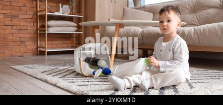 Kleiner Junge mit Waschmitteln zu Hause. Kind in Gefahr Stockfoto