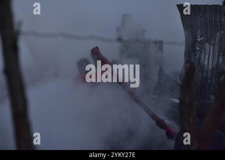 Srinagar, Jammu Und Kaschmir, Indien. November 2024. Die Menschen arbeiten daran, das Feuer in einem Rainawari-Gebiet im Zentrum von Srinagar, dem indischen Kaschmir, am 19. November 2024 zu begießen. Mehrere Wohnhäuser sind durch den massiven Brand in der Ortschaft schwer beschädigt. (Kreditbild: © Mubashir Hassan/Pacific Press via ZUMA Press Wire) NUR REDAKTIONELLE VERWENDUNG! Nicht für kommerzielle ZWECKE! Stockfoto