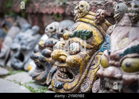 Souvenirmasken in der Nähe der Mauer auf dem nepalesischen Straßenmarkt, Kathmandu, Nepal. Stockfoto