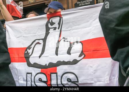 London, Großbritannien. April 2017. Märsche und Kundgebungen von Britain First und der EDL (English Defence League) als Reaktion auf den Londoner Terroranschlag wurden von dem Antifaschistischen Netzwerk, London Antifacists und Unite Against Facism (UAF) abgelehnt, die dem extremistischen Recht vorwerfen, den Angriff zu nutzen, um ihre antimuslimische und antimigrantische rassistische Propaganda anzuheizen. Ein EDL-Unterstützer blickt über eine Flagge mit einer Nachricht für ISIS vor dem Pub, in dem sie sich versammelten, und war auf dem Bürgersteig und schrie die Antifaschisten gegenüber an. Stockfoto