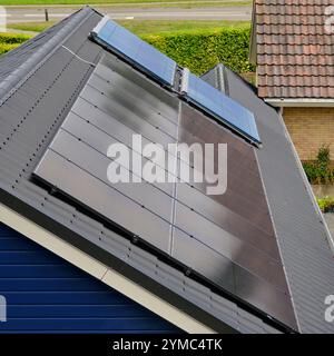 Auf dem Dach eines Wohnhauses installierte Solarpaneele zeigen die Integration erneuerbarer Energien in modernes Wohnen. Eine Demonstration von Sustaina Stockfoto