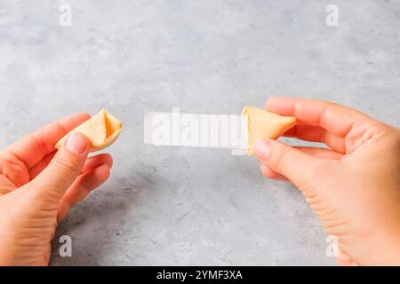 Nahaufnahme einer Hand, die einen Glückskeks mit einem leeren Stück Papier hält Stockfoto