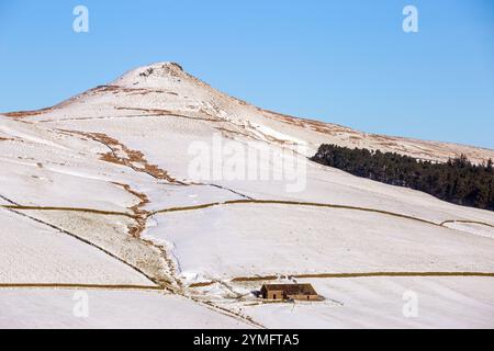 Shutlingsloe Hill in einer schneebedeckten Winterlandschaft des Cheshire Peak District mit einem einsamen Bauernhaus Stockfoto