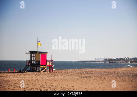 Rettungsschwimmer-Turm am ruhigen Strand unter klarem blauem Himmel Stockfoto
