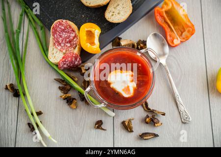 Fastenborsch mit getrockneten Pilzen und Gemüse auf einem hellen Holztisch. Stockfoto