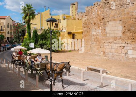 Kreta Tourismus, Blick im Sommer auf Touristen in Pferdekutschen, die eine Tour durch die alten venezianischen Stadtmauern in Chania (Hania), Kreta, Griechenland machen Stockfoto