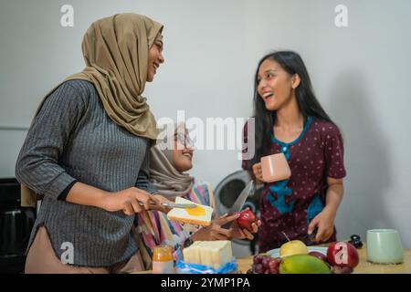 Freunde kochen zusammen in einer gemütlichen Küche voller Wärme und Lachen Stockfoto