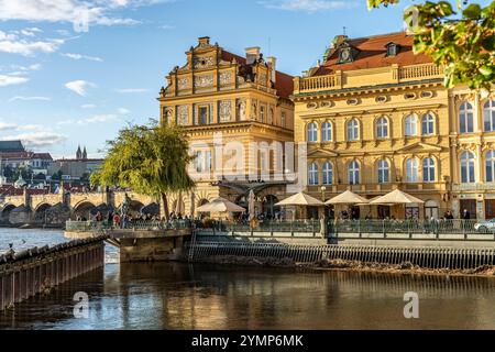 Smetana Embankment (Smetanovo nabrezi) entlang der Moldau, mit Whiel-Gebäude, Haus des Bedrich-Smetana-Museums, im Hintergrund, Prag, Tschechien Stockfoto