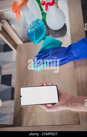 Zugeschnittenes Foto von Frau, die am Wochenende moderne Gadget-Kopierräume im Wohnraum des Hauses reinigt Stockfoto