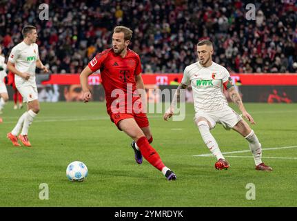 Harry Kane (FC Bayern München, #9) und Jeffrey Gouweleeuw (FC Augsburg, #6). GER, FC Bayern München gegen den FC Augsburg, Fussball, Bundesliga, 11. Spieltag, Spielzeit 2024/2025, 22.11.2024. (DIE DFL-DFB-VORSCHRIFTEN VERBIETEN DIE VERWENDUNG VON FOTOS ALS BILDSEQUENZEN UND/ODER QUASI-VIDEO). Foto: Eibner-Pressefoto/Heike Feiner Stockfoto