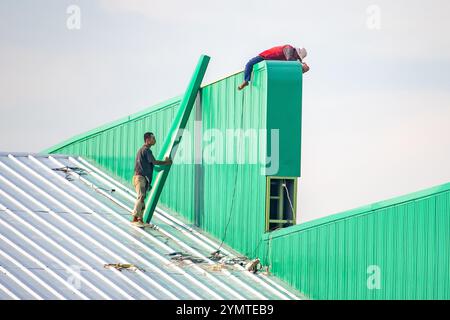 SAMUT PRAKAN, THAILAND, 26. Oktober 2024, Arbeiter arbeiten auf dem Dach der Halle Stockfoto