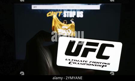 Stuttgart, Deutschland, 03.07.2024: Person mit Handy mit Logo der Kampfsportfirma Ultimate Fighting Championship (UFC) vor Web pag Stockfoto