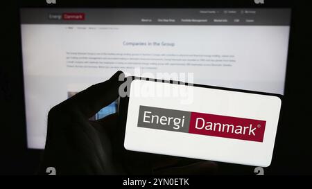 Stuttgart, Deutschland, 03.01.2024: Person, die ein Smartphone mit dem Logo des dänischen Energiehandelsunternehmens Energi Danmark vor der Website hält. Fokus auf p Stockfoto