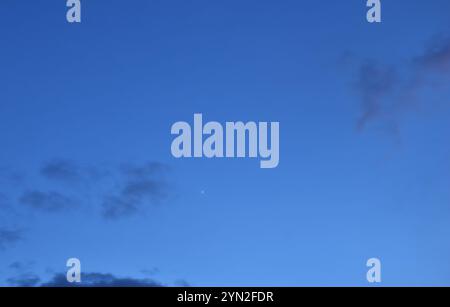venus-Stern am hellblauen Himmel mit dunkler Wolke am Abend Stockfoto