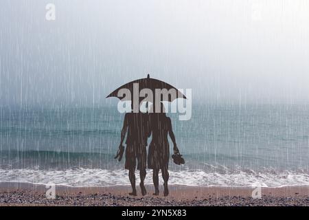 Barfuß liebevolles Paar am Strand mit einem Sonnenschirm im Regen Stockfoto