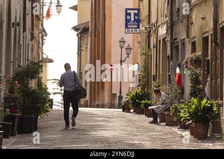 MONTAIONE, ITALIEN, 10. SEPTEMBER 2023, Ein Mann, der durch eine Straße im kleinen Dorf Montaione in der Toskana, Italien, Europa, läuft Stockfoto