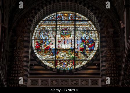 SIENA, ITALIEN, 23. SEPTEMBER 2023, reich verziertes Fenster des Kirchenschiffs der Kathedrale von Siena in Italien, das das letzte Abendmahl Christi zeigt Stockfoto