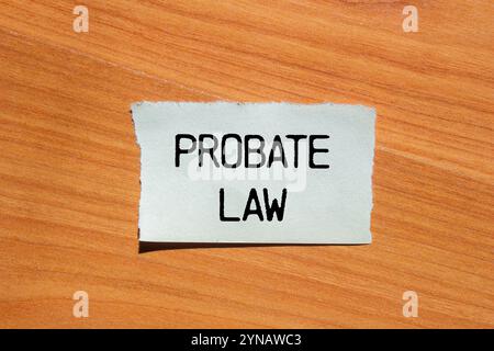 Nachricht zum Nachlassgesetz geschrieben auf zerrissenem Papierstück mit hölzernem Hintergrund. Symbol für das konzeptionelle Nachlassgesetz. Kopierbereich. Stockfoto