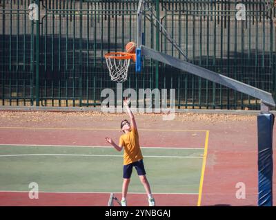 Das Kind schießt Basketballkörbe Stockfoto