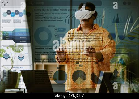 Transparente VR-Geschäftspräsentation vor reiferen weiblichen Telearbeitern Stockfoto