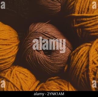 Balls of cozy, fluffy wool in a variety of hues, perfect for crafting garments and blankets during the winter, are a delightful pastime that can serve Stockfoto