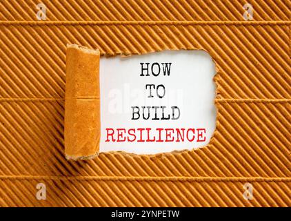 So erstellen Sie ein Resilienzsymbol. Konzeptworte wie man Resilienz auf einem schönen Whitepaper aufbauen kann. Schöner brauner Hintergrund. Unternehmen und wie man baut Stockfoto