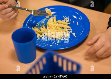 Berlin, Deutschland. November 2024. Nur ein Kind hat Pasta und Käse auf seinem Teller beim Schulessen. Quelle: Jens Kalaene/dpa/Alamy Live News Stockfoto