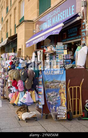 Marseille. Frankreich - 27. November 2024: Touristen erkunden einen lebhaften Straßenmarkt in Marseille, der mit verschiedenen Souvenirs, Hüten und lokalen Produkten gefüllt ist. Stockfoto