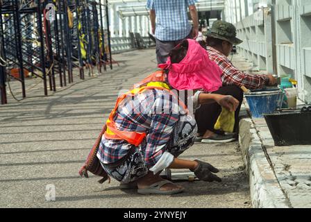 Pattaya, Thailand - 9. Oktober 2024: Bali Hai Eine Thailändin und ein Mann in Arbeitskleidung restaurierten den kleinen Steg auf Bali Hai. Stockfoto