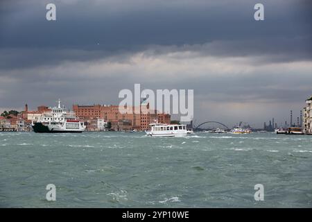 01.07.2024, Italien, Veneto, Venedig - Venedig, Veneto, Italien - Blick von Venedig-San Marco über den Kanal von Giudecca unter stürmischem Himmel. Eine Autofähre und Stockfoto