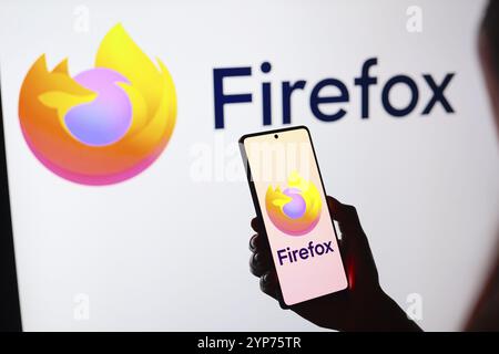 In dieser Fotoabbildung wird das Logo des Mozilla Firefox Webbrowsers auf einem Smartphone-Bildschirm und im Hintergrund angezeigt Stockfoto