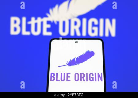 In dieser Fotoabbildung wird das blaue Origin-Logo auf einem Smartphone-Bildschirm und im Hintergrund angezeigt Stockfoto