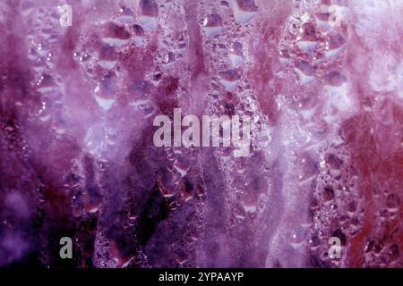 Deilcate Regentropfen Wasser auf Glas in einem rosa Glow für Hintergrund Stockfoto