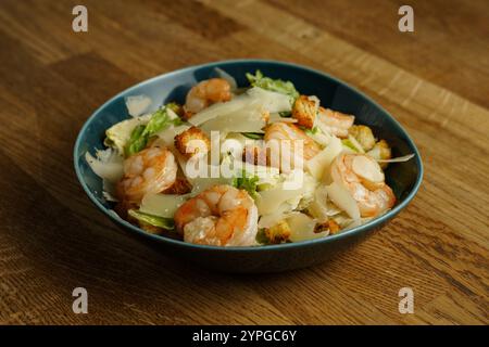 Eine herzhafte Schüssel Shrimp Caesar Salat mit Garnelen, knusprigen Romaine Salat, knusprigen Croutons und dünn geschliffenem Parmesan Käse. Das Gericht wird serviert Stockfoto