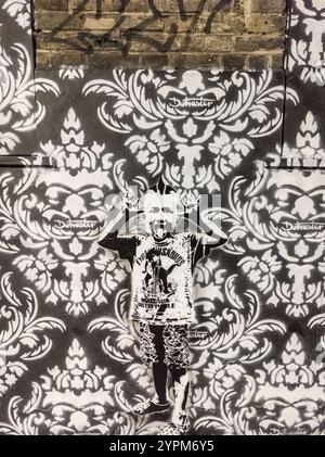 Trendige Urban Street Art mit Punk-inspiriertem Schablonenschablone auf gemusterter Wand mit auffälliger Graffiti-Ästhetik im monochromatischen Stil Stockfoto