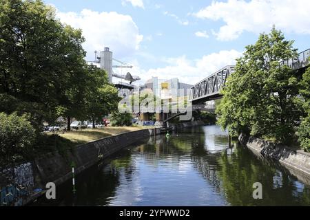 Berlin, 11. Juli 2022, Blick über den Landwehrkanal mit eiserner Trägerbrücke der Hochbahn, BVG-Schild und der alten DC 3 am Museum Stockfoto