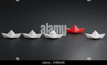 Roter Vogel schwimmt zwischen weißem Vogel Papierkran. 3D Illustration Vogelpapier Handwerk für Hiroshima Gedenktag Minimal Style Konzept.3D Rendering auf b Stockfoto