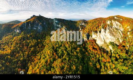 Farbenfroher Wald bei Sonnenuntergang im Herbst. Blick von oben auf die Berge im Wald. Wunderschöne Landschaft mit roten und orangen Blättern im Herbst. Slowakei - Sulov Stockfoto