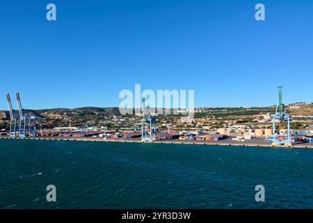 Marseille. Frankreich - 2. Dezember 2024: Der Hafen von Marseille an einem klaren Tag, mit einer Fähre und einem Kreuzfahrtschiff am Terminal, und die Stadt und mountai Stockfoto