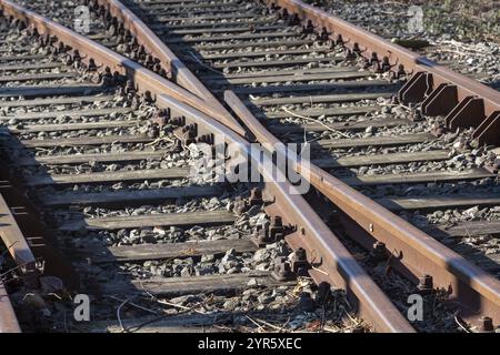 Nahaufnahme von rostigen Bahnübergangsgleisen, die eng miteinander verbunden sind Stockfoto