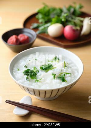 Reisbrei mit sieben Kräutern und eingelegten Pflaumen Stockfoto